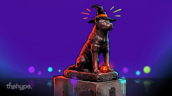 Illustrated Hachiko dog statue in a witch hat next to a glowing jack-o'-lantern on a neon Halloween night in Shibuya